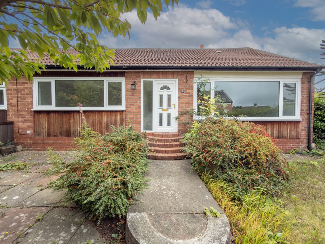 A spacious corner-plot bungalow bursting with potential.